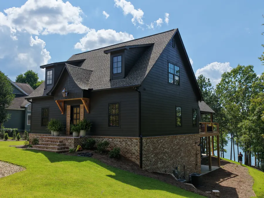 Custom lake house exterior overlooking the water, built by Still Oak Homes