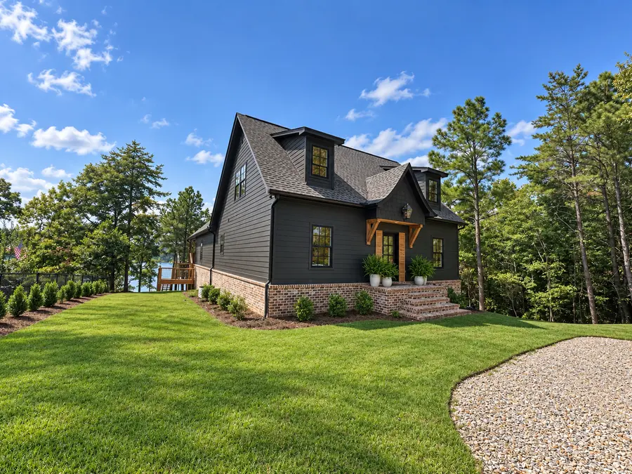 Side exterior of a dark custom lake house built by Still Oak Homes