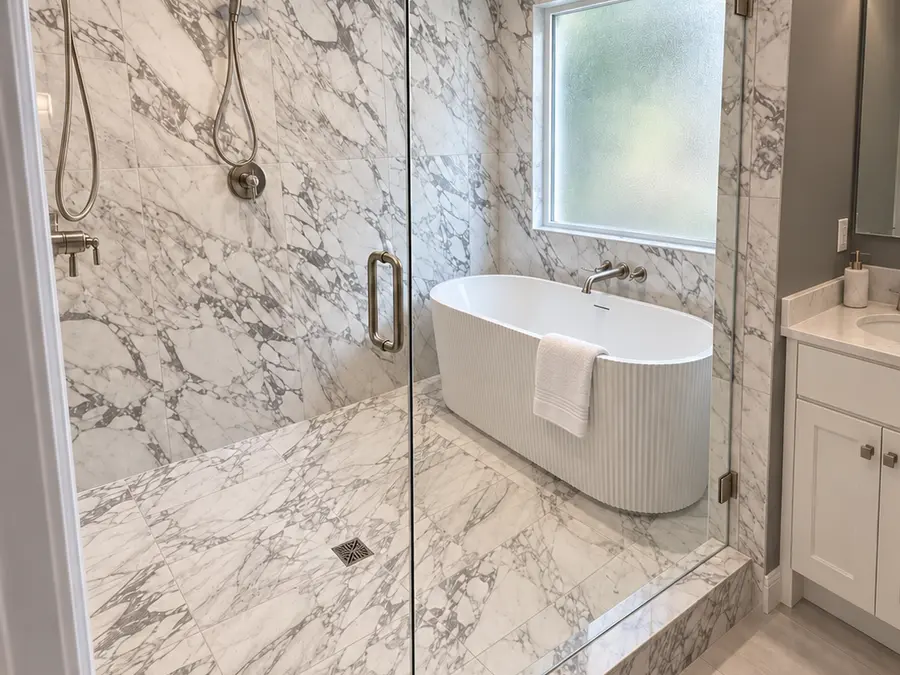 Primary bathroom with marble walk-in shower and freestanding tub by Still Oak Homes